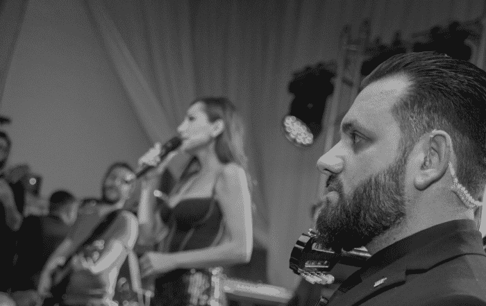 Security guard in a black suit providing security services in London for a celebrity singer