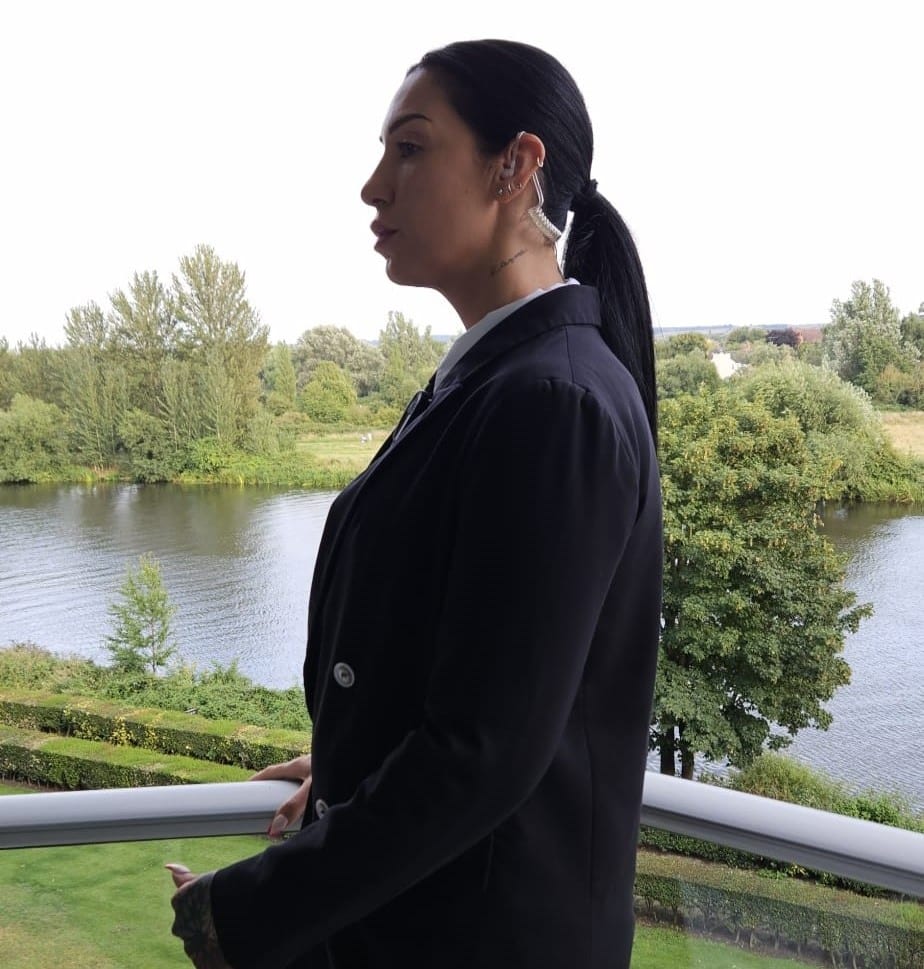 Female licensed bodyguard on duty in private estate in London.